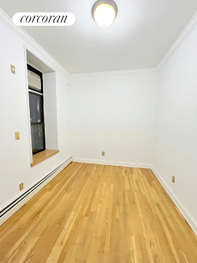 empty room featuring light wood-style flooring, ornamental molding, baseboards, and a baseboard radiator