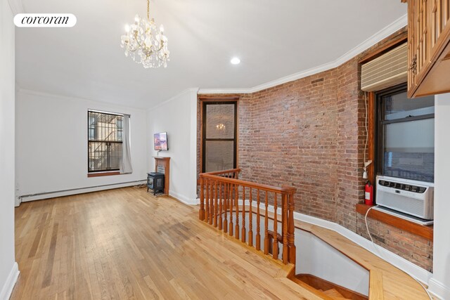 5 W 107th St Unit 1A, New York City, NY 10025 - corridor featuring an upstairs landing, a baseboard heating unit, ornamental molding, baseboards, and brick wall