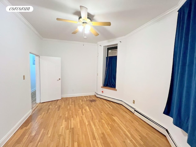 empty room with light wood-type flooring, visible vents, ornamental molding, baseboard heating, and ceiling fan