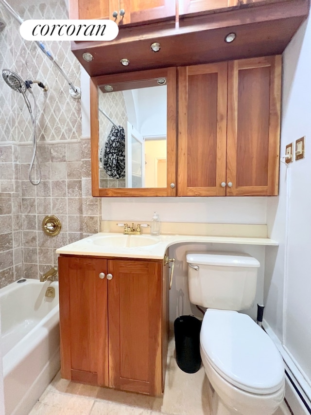 full bath featuring vanity, toilet, baseboard heating, and washtub / shower combination