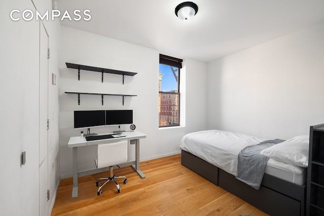 bedroom featuring wood finished floors and baseboards