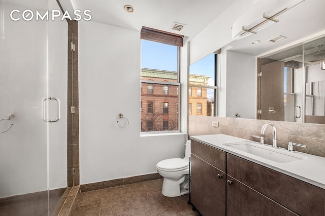 full bath featuring visible vents, a stall shower, vanity, baseboards, and toilet