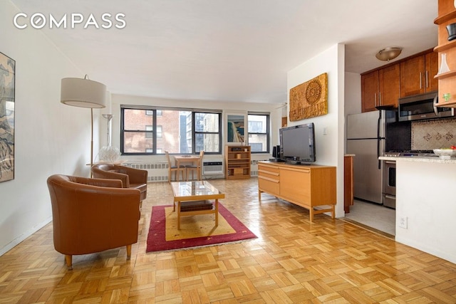 living area with radiator and baseboards