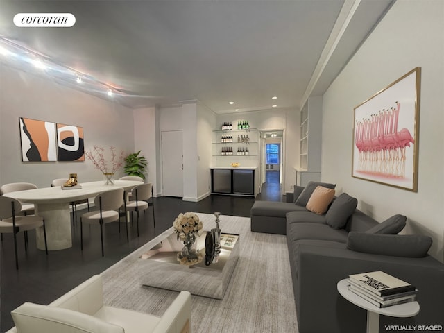 living room with recessed lighting, visible vents, and wood finished floors