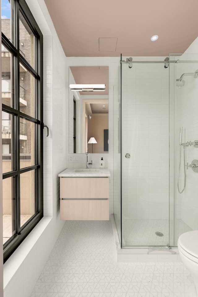 303 W 113th St Ph, Ph, New York City, NY 10026 - bathroom featuring a stall shower, toilet, vanity, tile patterned flooring, and recessed lighting