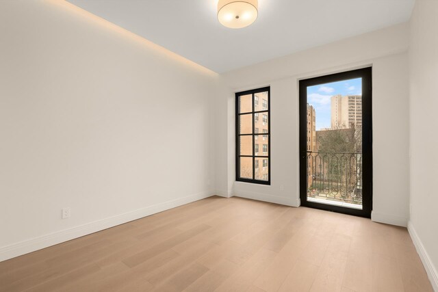 303 W 113th St Ph, Ph, New York City, NY 10026 - unfurnished room with light wood finished floors and baseboards