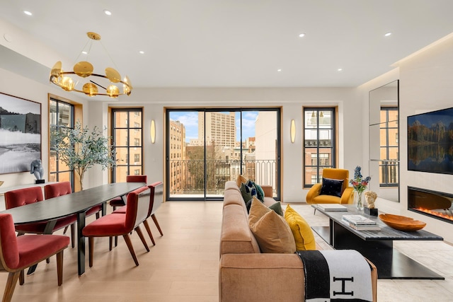 303 W 113th St Ph, Ph, New York City, NY 10026 - living area with a chandelier, recessed lighting, a large fireplace, and light wood-style flooring