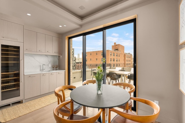 303 W 113th St Ph, Ph, New York City, NY 10026 - dining area featuring beverage cooler, recessed lighting, light wood-style flooring, a view of city, and bar
