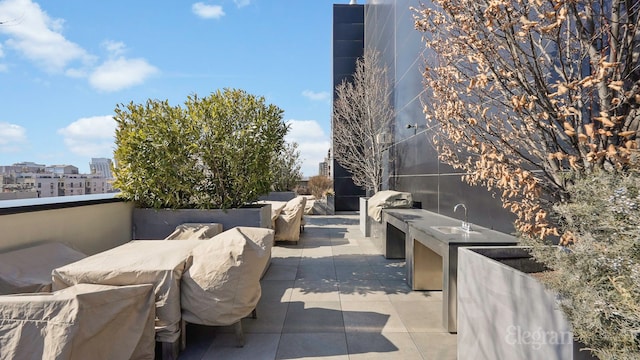 view of patio featuring a view of city and an outdoor kitchen