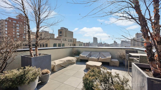 view of patio / terrace featuring a view of city and outdoor lounge area