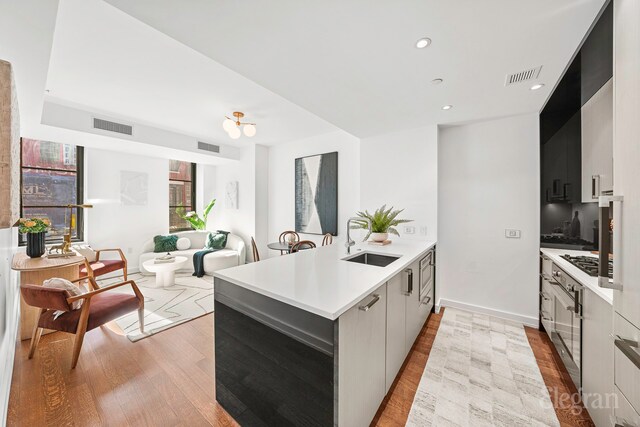 261 W 25th St Unit 1-C, New York City, NY 10001 - sitting room with wood finished floors, baseboards, and visible vents