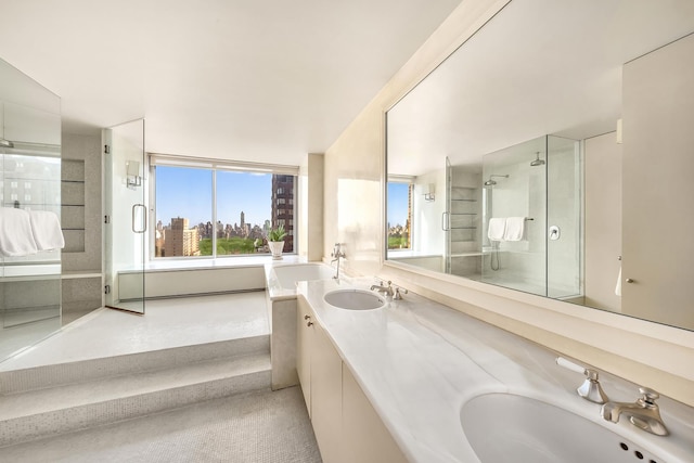 full bath with double vanity, a stall shower, and a sink