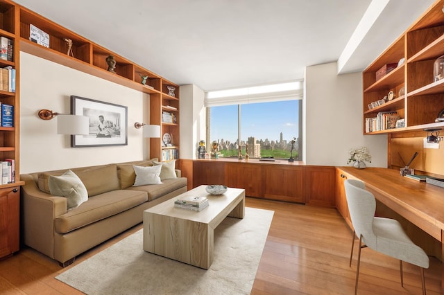 living room with light wood-style flooring and built in desk