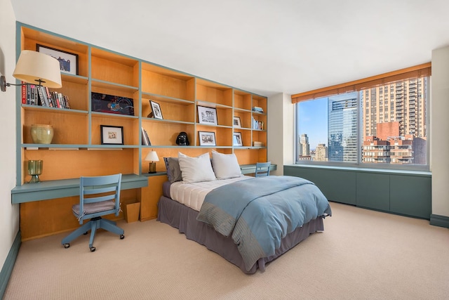 bedroom with a city view, carpet flooring, and built in desk