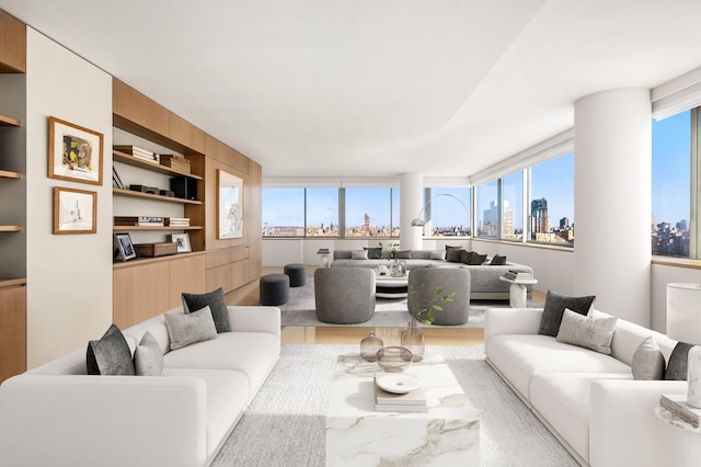 living area with built in features, a city view, and wood finished floors