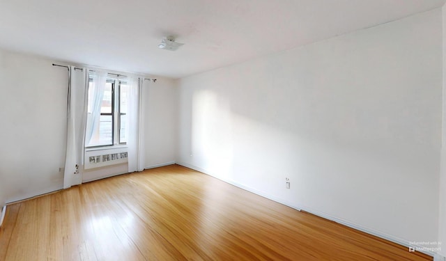 spare room featuring light wood finished floors