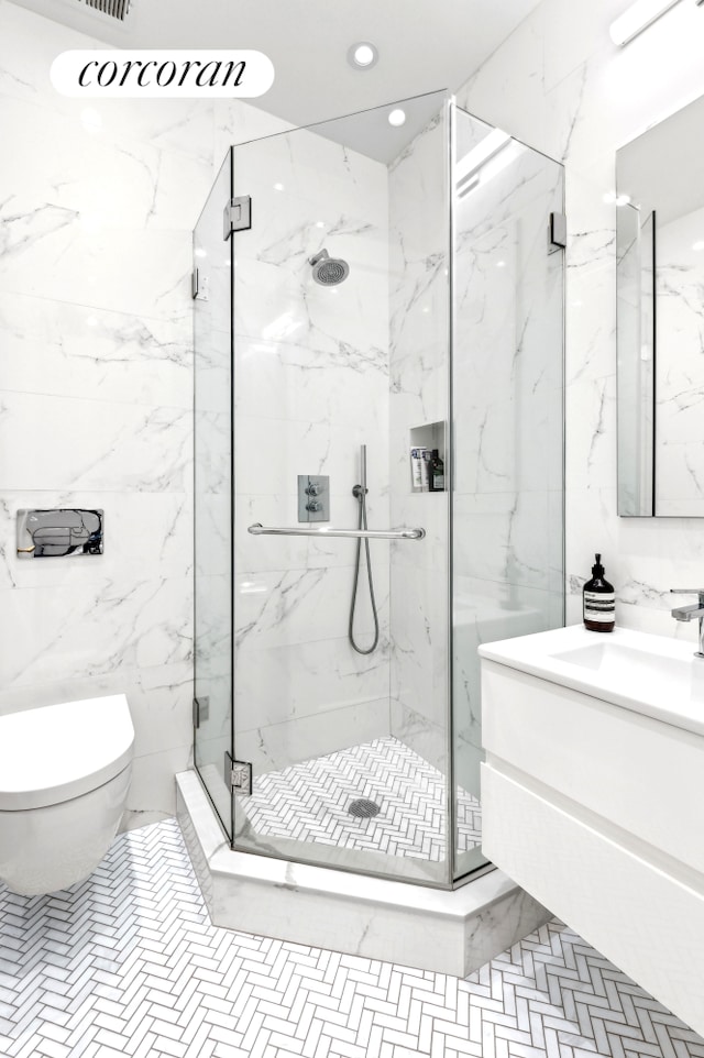 299 Riverside Dr Unit 3C, New York City, NY 10025 - bathroom featuring a marble finish shower, toilet, tile walls, vanity, and recessed lighting