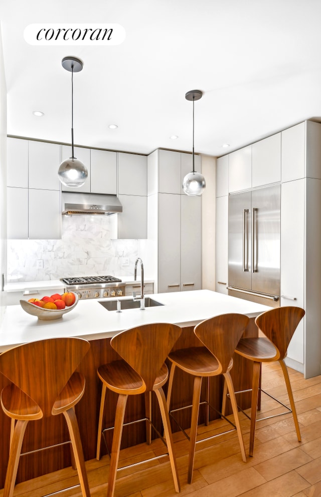 299 Riverside Dr Unit 3C, New York City, NY 10025 - kitchen featuring modern cabinets, under cabinet range hood, white cabinets, and a sink