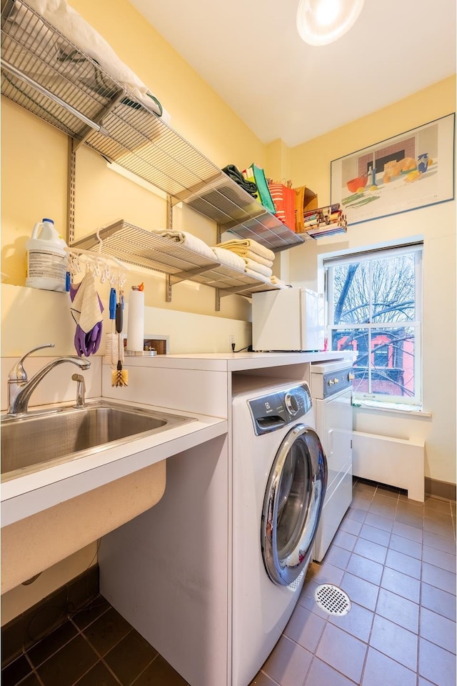 laundry room with laundry area, dark tile patterned flooring, and independent washer and dryer