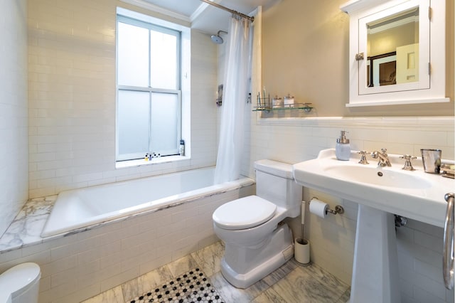 bathroom featuring toilet, tile walls, and tiled shower / bath