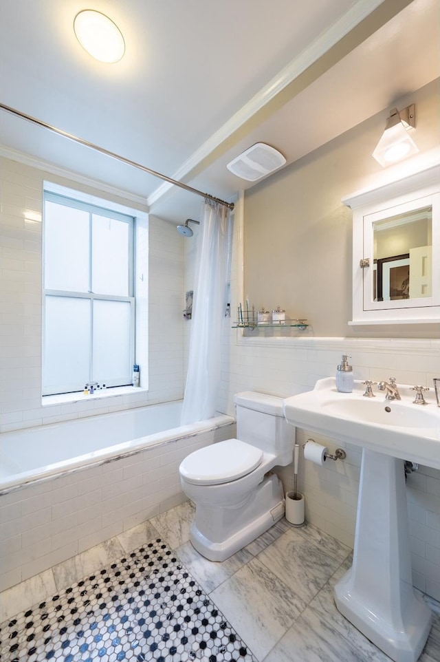 bathroom featuring visible vents, toilet, ornamental molding, tiled shower / bath combo, and tile walls