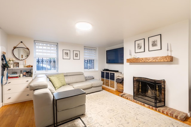 living room with a fireplace and wood finished floors