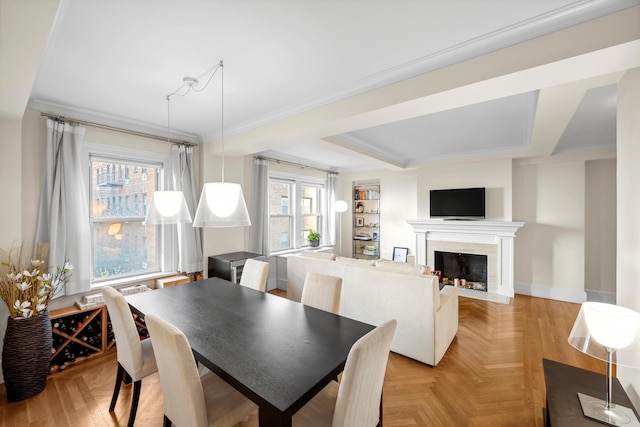 dining space with a fireplace, crown molding, and baseboards