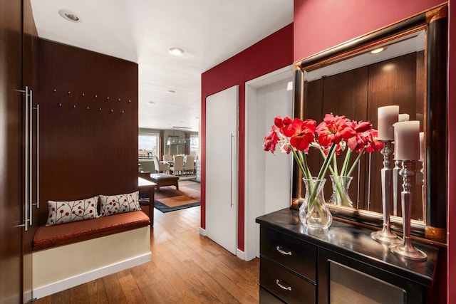 corridor featuring hardwood / wood-style flooring and baseboards