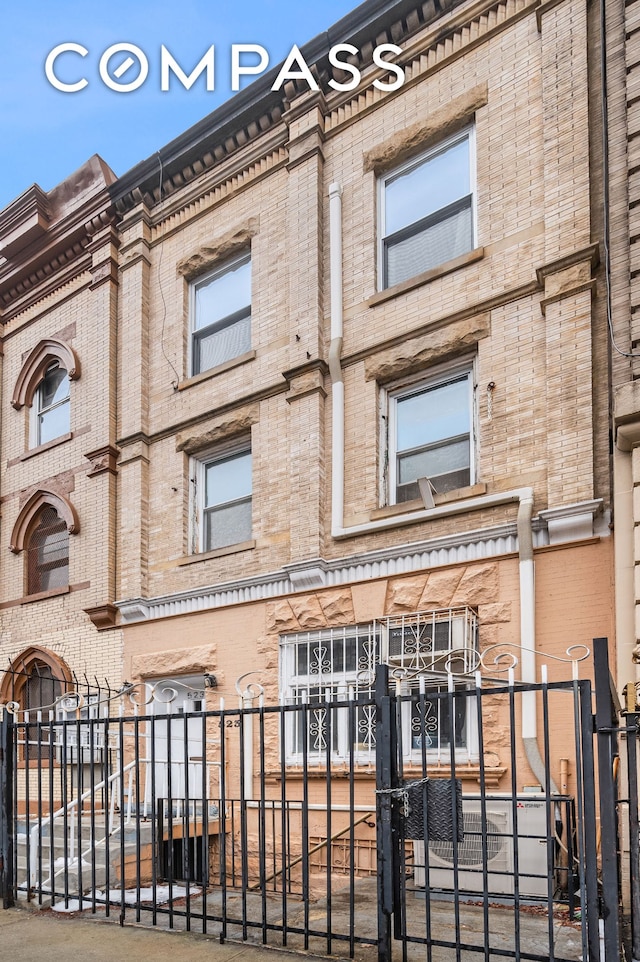 view of building exterior with a fenced front yard