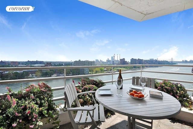 balcony featuring a view of city and a water view