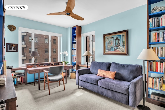 living area featuring carpet flooring, ceiling fan, and visible vents