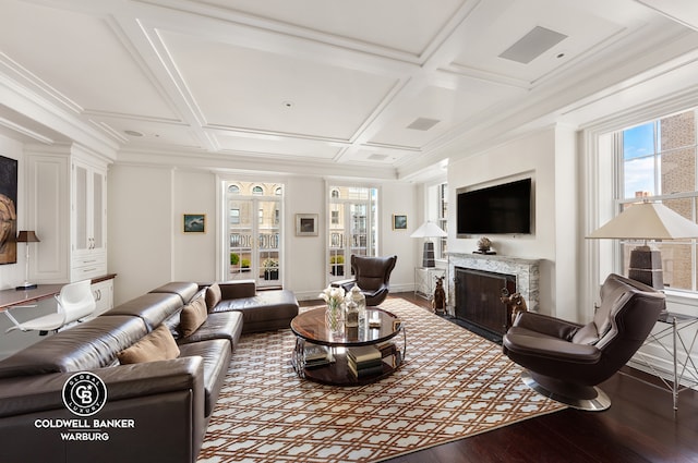 living room with coffered ceiling, wood finished floors, a high end fireplace, baseboards, and ornamental molding