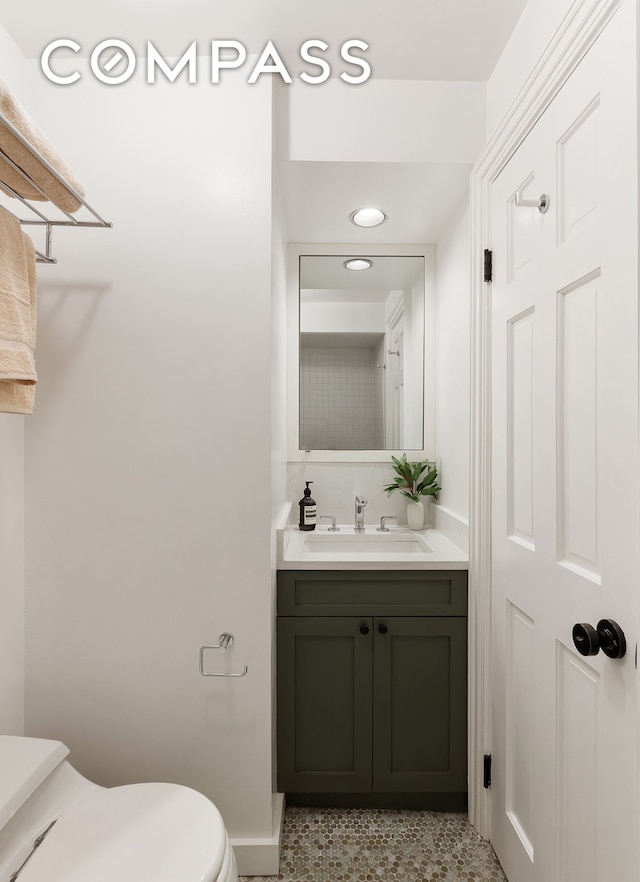 half bath with vanity and toilet