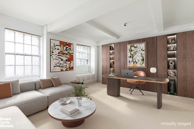 carpeted home office with beam ceiling and wood walls