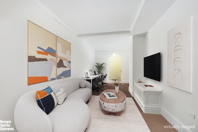 living room with arched walkways, beam ceiling, and baseboards