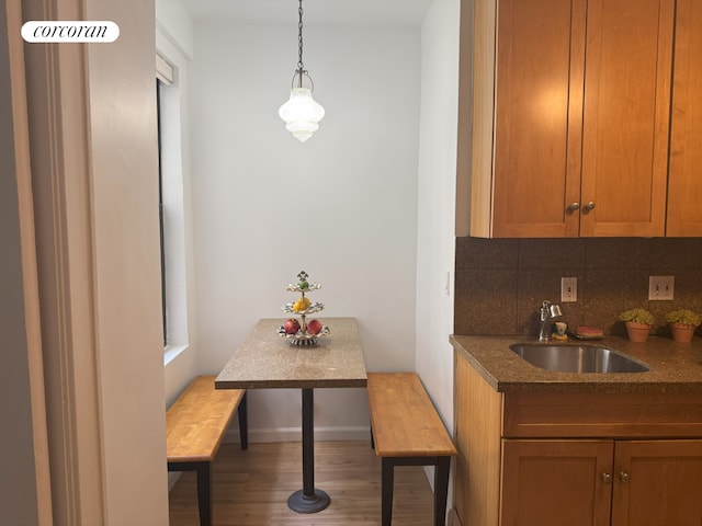 600 W 111th St Unit 10D, New York City, NY 10025 - kitchen featuring wood finished floors, tasteful backsplash, dark countertops, and brown cabinetry
