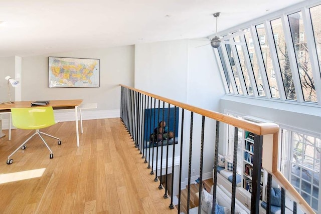 hallway featuring wood finished floors and baseboards
