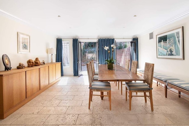 dining space featuring ornamental molding, stone tile flooring, and visible vents