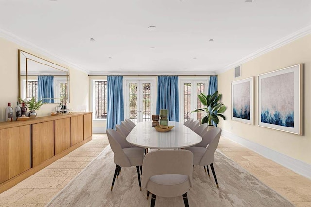 dining area featuring baseboards, french doors, and crown molding