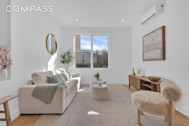 living area featuring recessed lighting, baseboards, wood finished floors, and a wall mounted AC