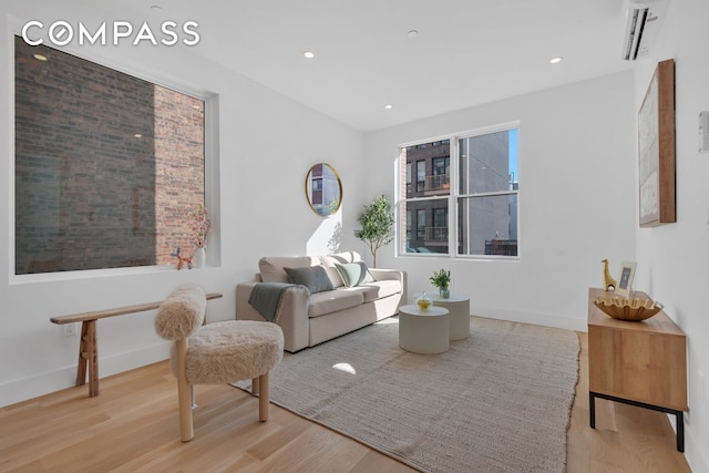 living room with recessed lighting, wood finished floors, and baseboards