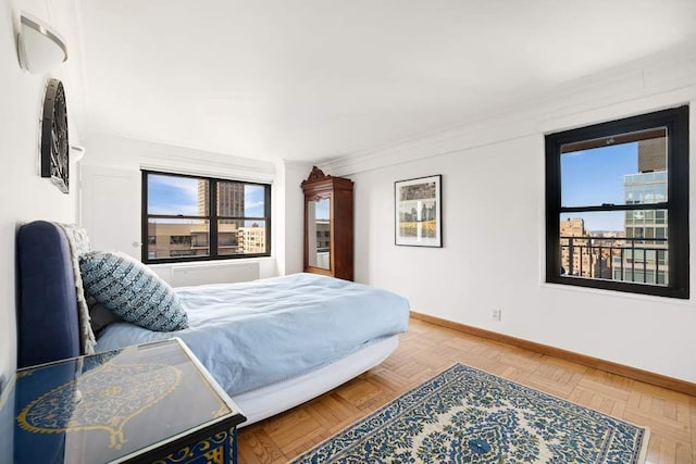 bedroom with ornamental molding and baseboards