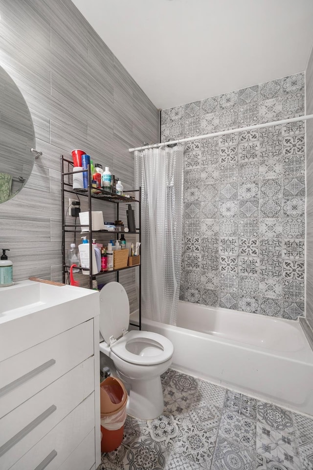 full bathroom with shower / tub combo, tile patterned floors, toilet, and tile walls