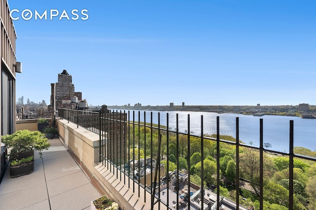 balcony featuring a city view and a water view