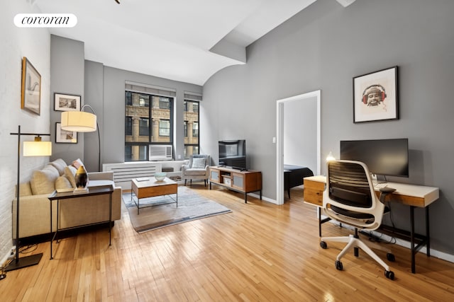 office space featuring hardwood / wood-style flooring, visible vents, and baseboards