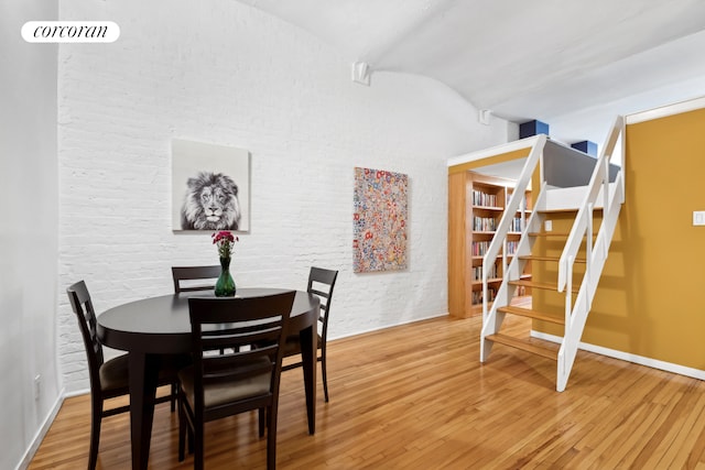39 E 12th St Unit 507, New York City, NY 10003 - dining room with wood finished floors, lofted ceiling, baseboards, and stairs