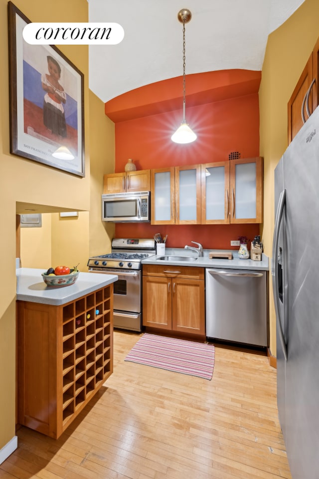 39 E 12th St Unit 507, New York City, NY 10003 - kitchen with stainless steel appliances, light wood-style floors, light countertops, hanging light fixtures, and lofted ceiling