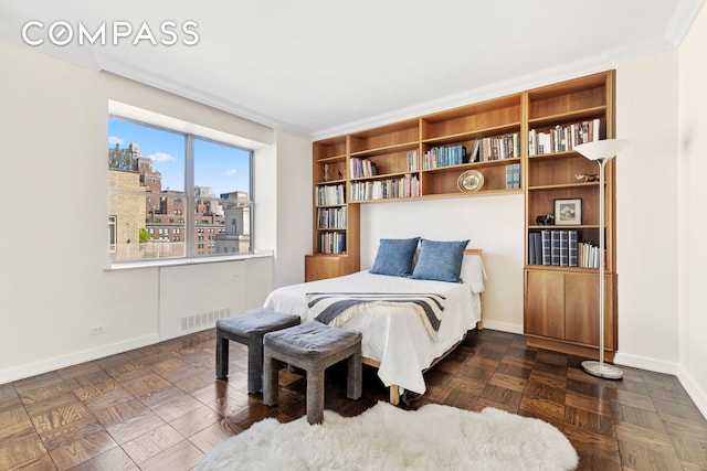 bedroom featuring baseboards, crown molding, visible vents, and a city view