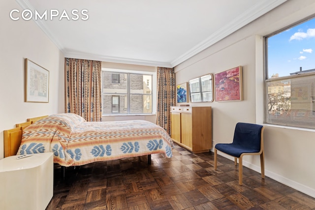 bedroom featuring multiple windows, baseboards, and ornamental molding