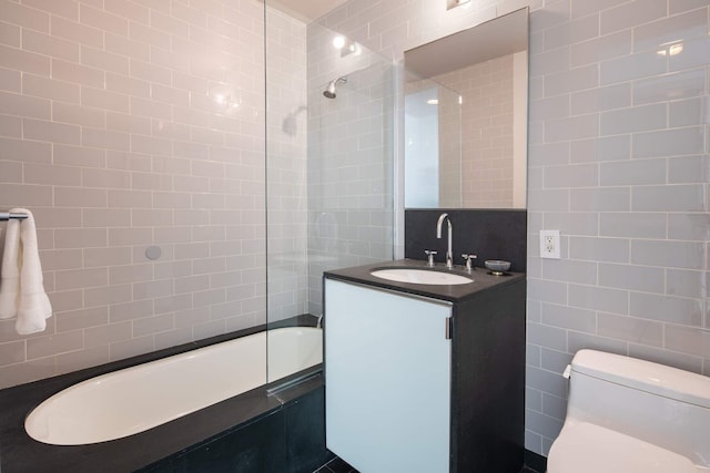 full bath with toilet, tile walls, and vanity